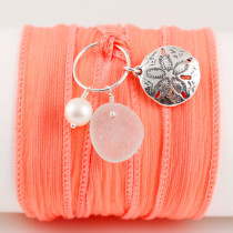 Our sea glass silk wrap bracelet is the most versatile piece of jewelry you'll own. It can be worn as a one-size-fits-all bracelet, another time it can be tied at the back of your neck to wear as a necklace. And for a completely different look, the entire charm (sea glass, pearl and sterling silver charm) can be untied from the ribbon and worn on a necklace! The sea glass is genuine, the pearl is freshwater and the charm and all elements are sterling silver. The silk ribbon is 34-36" long and is one size fits all. It is hand washable and can be lightly ironed. The silk ribbon color shown is aqua and it comes with the treble clef. However you can choose from 17 other charms (see below) to customize this design.