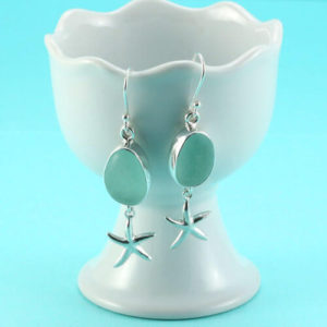 Gorgeous, well-matched sea glass gems make a stunning pair of genuine, sea foam sea glass earrings bezel set in sterling silver. This is a pair sure to garner many compliments for the wearer. The sea foam hue is soft and soothing, like the color of calming waters. We send each pair with soft rubber backs. The sea glass is genuine, beach found and never altered. We offer a money back guarantee if you are not completely satisfied. Add that to fast, free shipping, free gift wrap, and an anti-tarnish storage bag and you can't go wrong. Buy genuine sea glass jewelry from a full time sea glass artisan. Free gift with each purchase! One pair available. Metal: Sterling Silver Ear Wires and Accents Origin of Sea Glass: California Rarity: Jewelry Quality Sea Foam is Uncommon Size of Sea Glass: 5/8" Long and 5/8" Wide Drop from Earlobe: 1-1/4" One Pair Available [cc_product sku="e204" display="inline" quantity="true" price="true"] View All Sea Foam Sea Glass Earrings Here!