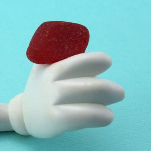 Red Sea Glass With Plastic Doll Hand Copyright Sea Glass Jewelry by Jane