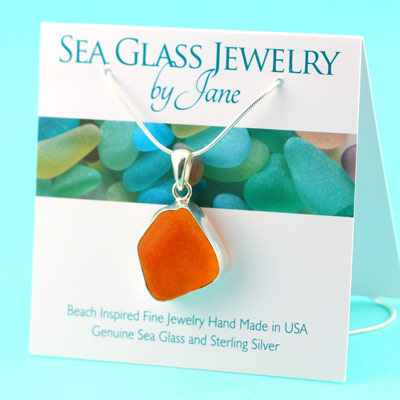 Stunning sea glass pendant with a duo of rare beach glass set on a sterling fashion silver setting | UV orange and Blue sea glass necklace